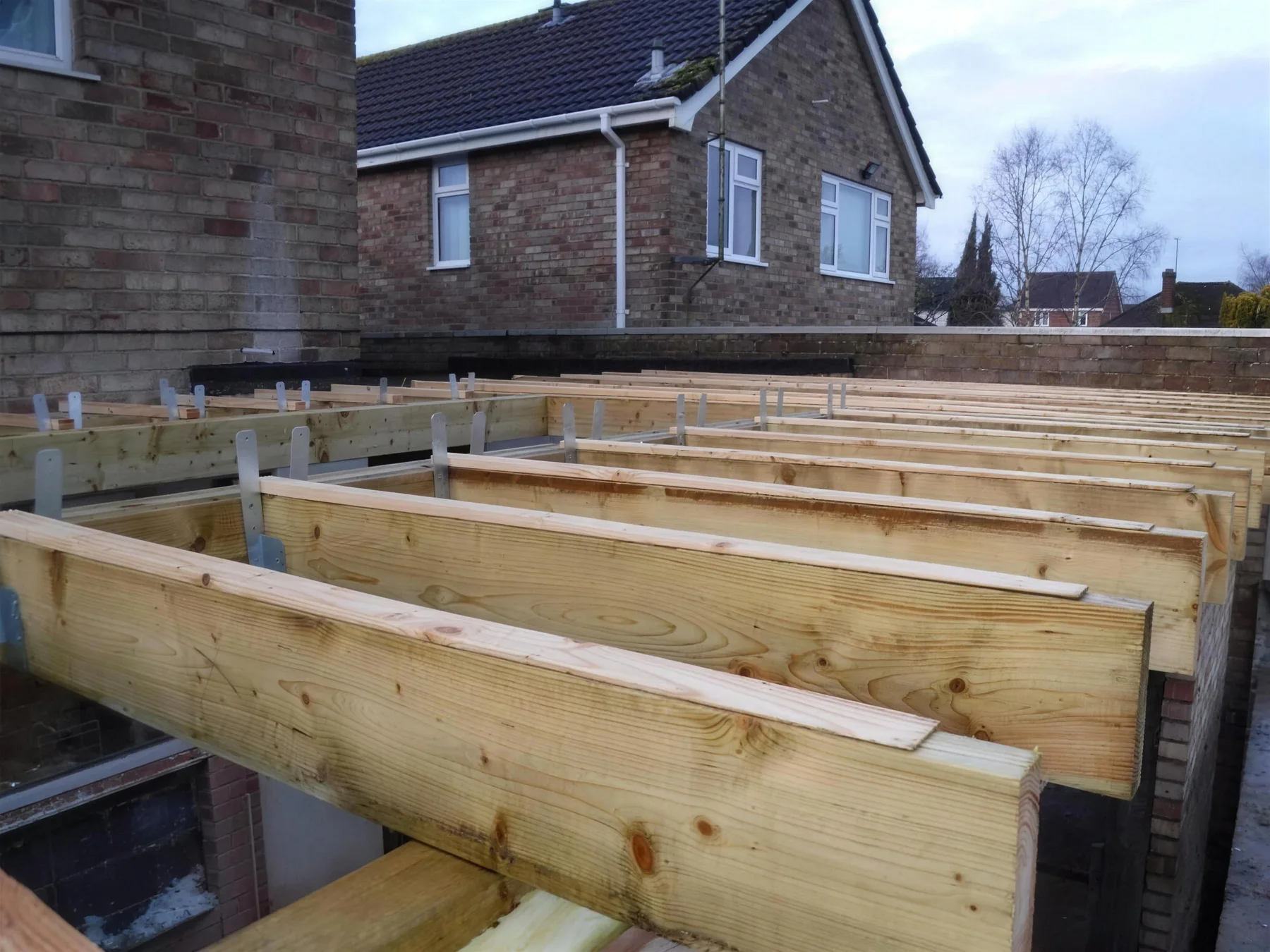 Floor joists going in on a house extension by A.P. Berrystone at Farrfield, Stratton